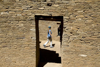 A tourist walks among the ruins of Pueblo Bonito at Chaco Canyon National Historic Park on Tuesday. Hundreds of visitors made the trip for the annual summer solstice celebration. © 2011 Gallup Independent / Brian Leddy 